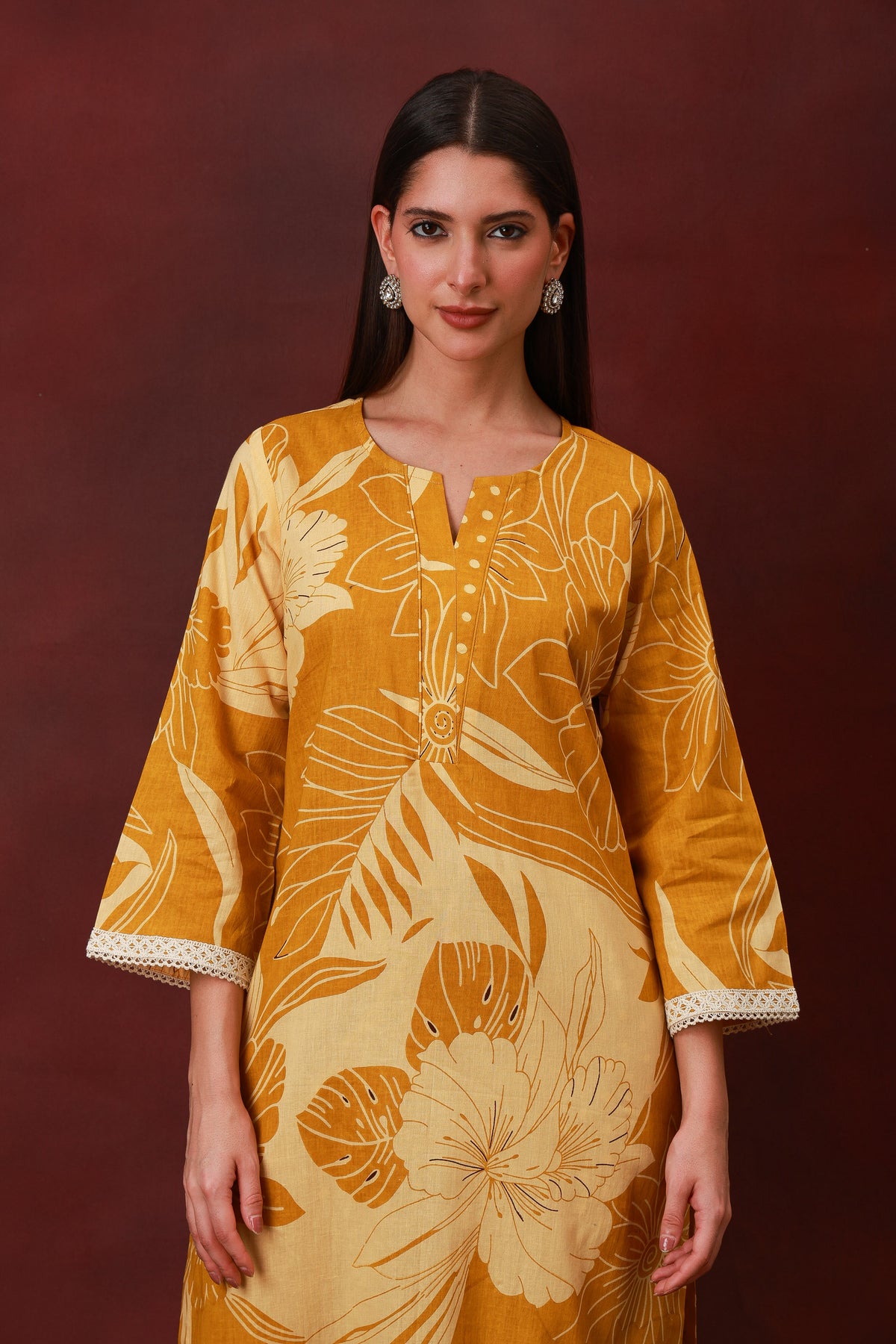 Model wearing the Kanak mustard floral cotton three-piece suit with dupatta