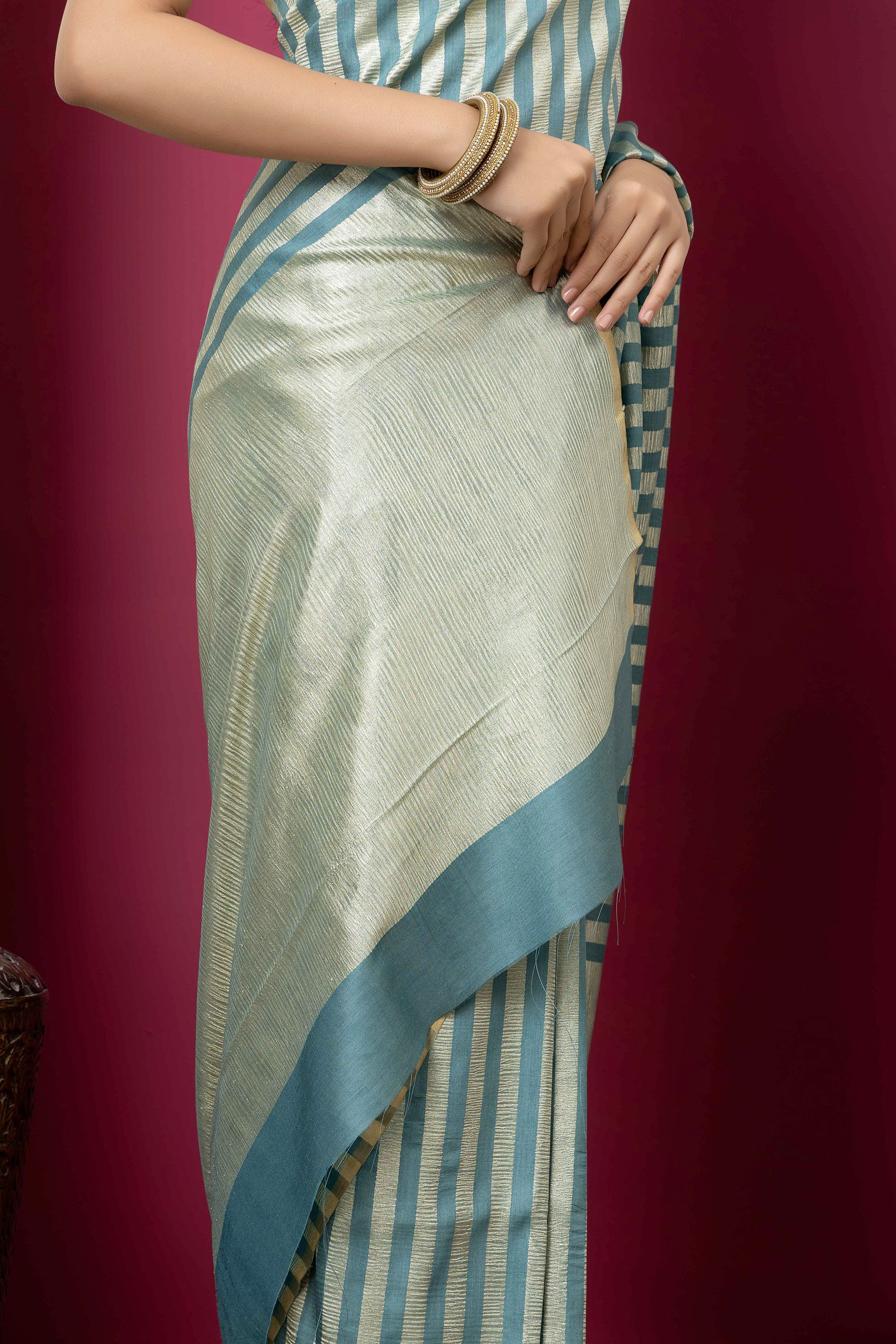 Beautiful Banarasi green pure Muga silk saree with alternate stripes of crinkled tissue and zari pallu