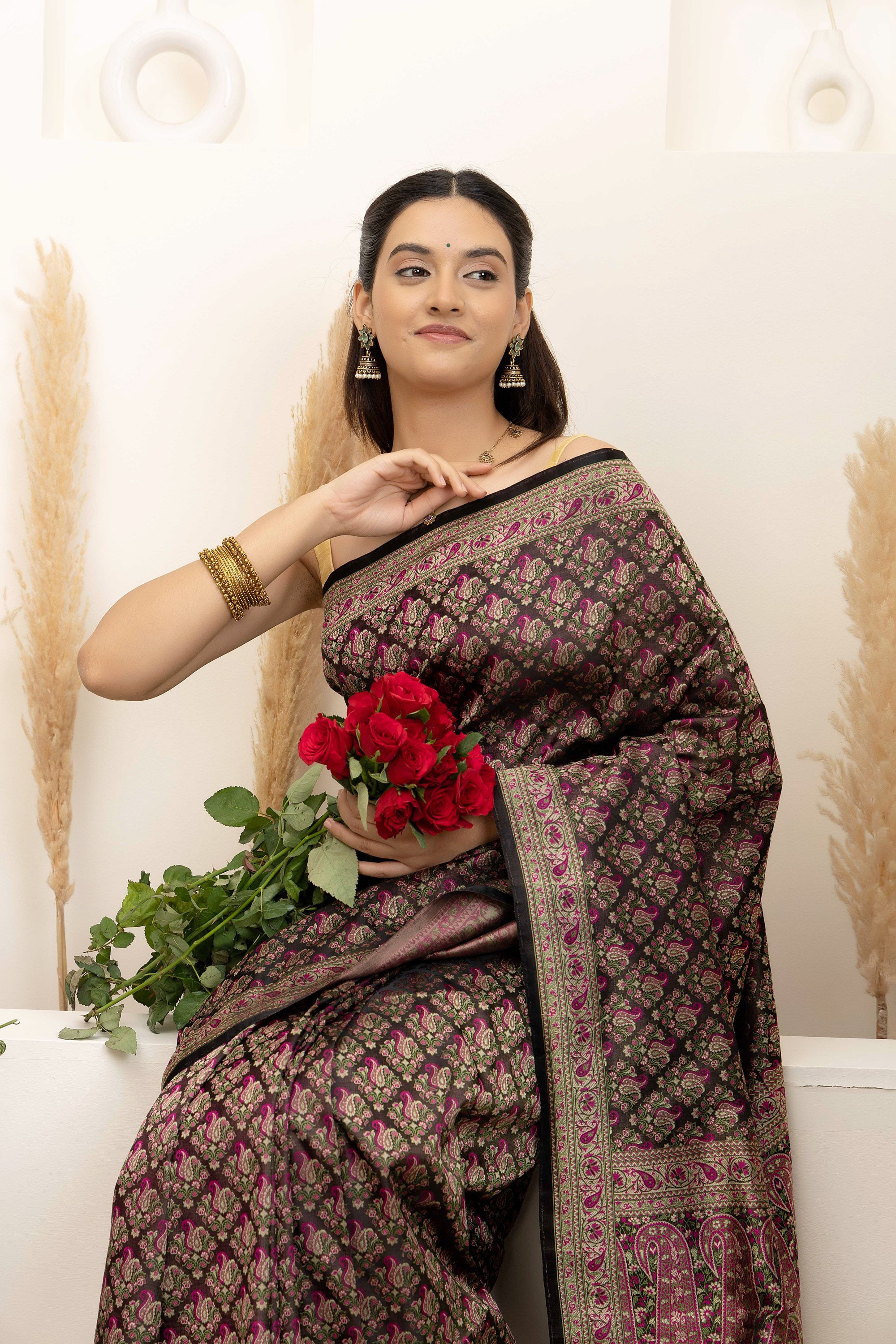 Banarasi pure silk tanchui saree. It’s a rich majenta on brown undertone saree with intricate resham weaving