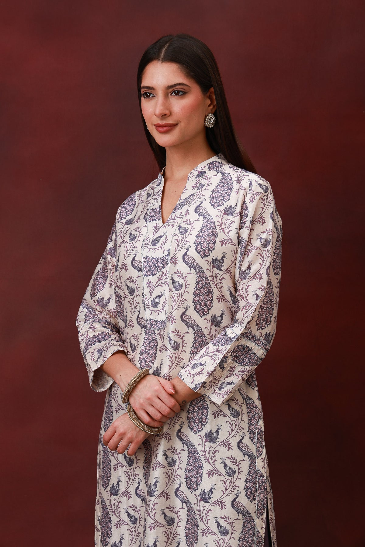 Model wearing the Ivory peacock print Chanderi silk suit with plum dupatta