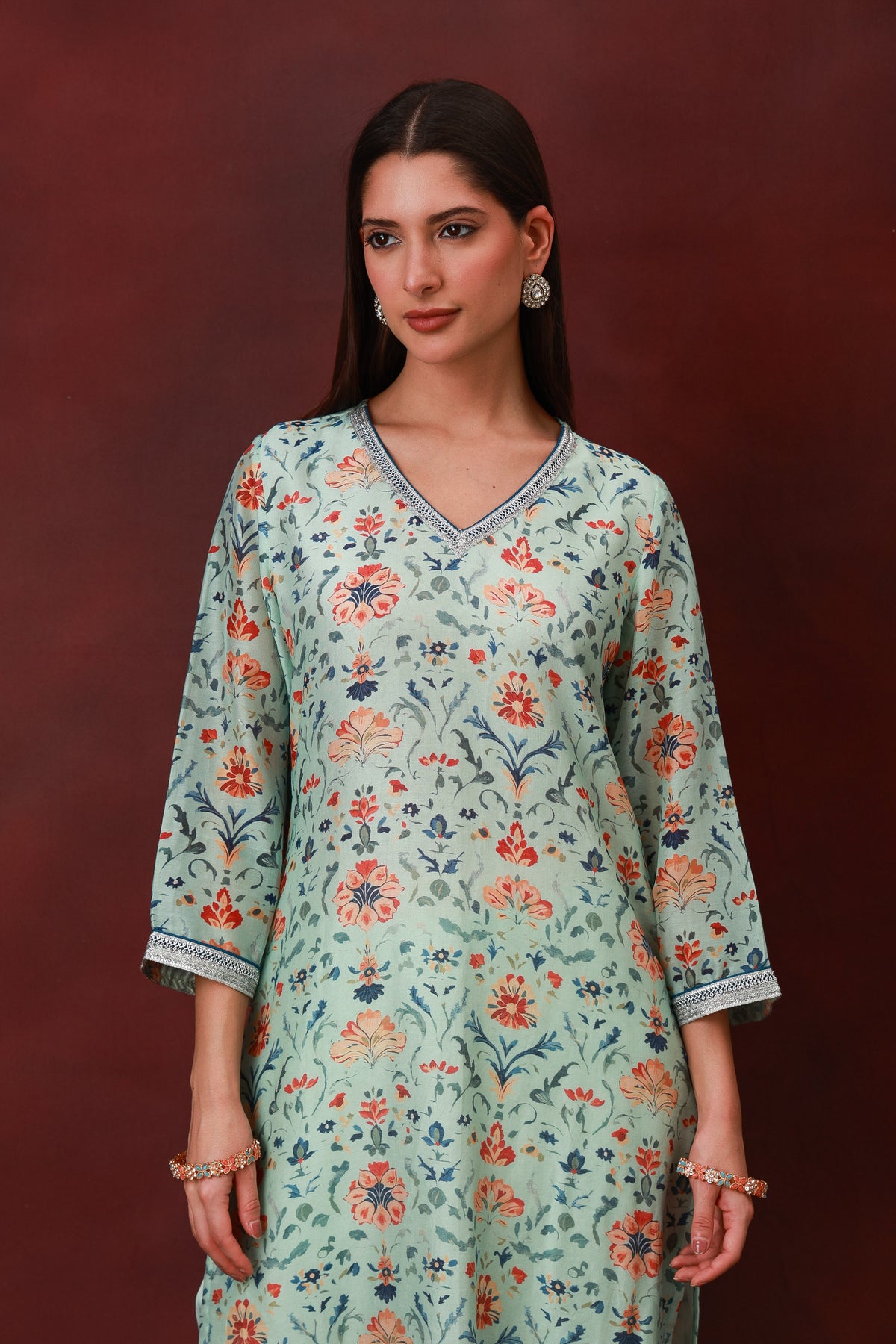 Model wearing the Nirvi sea green floral Chanderi silk suit with navy dupatta