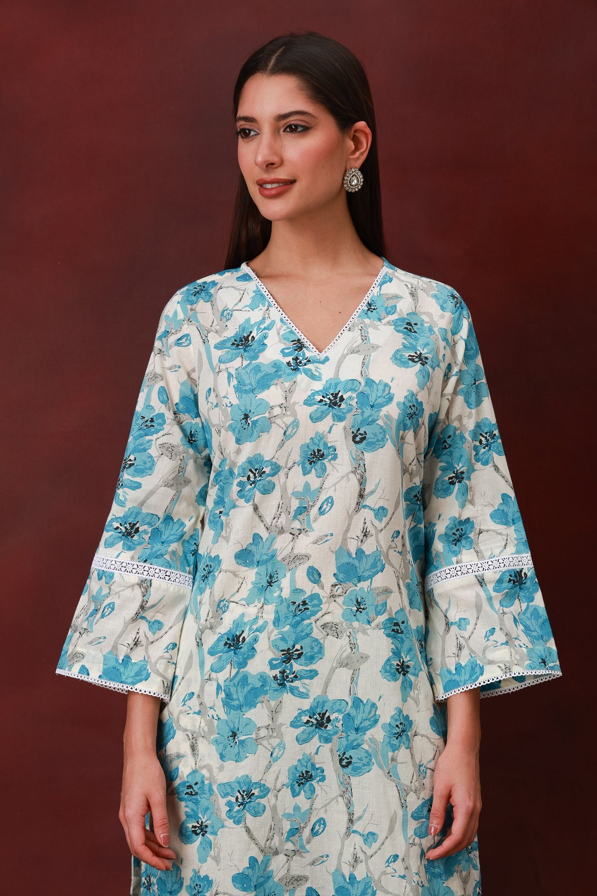 Model wearing the Neelbahar blue floral cotton three-piece suit with dupatta