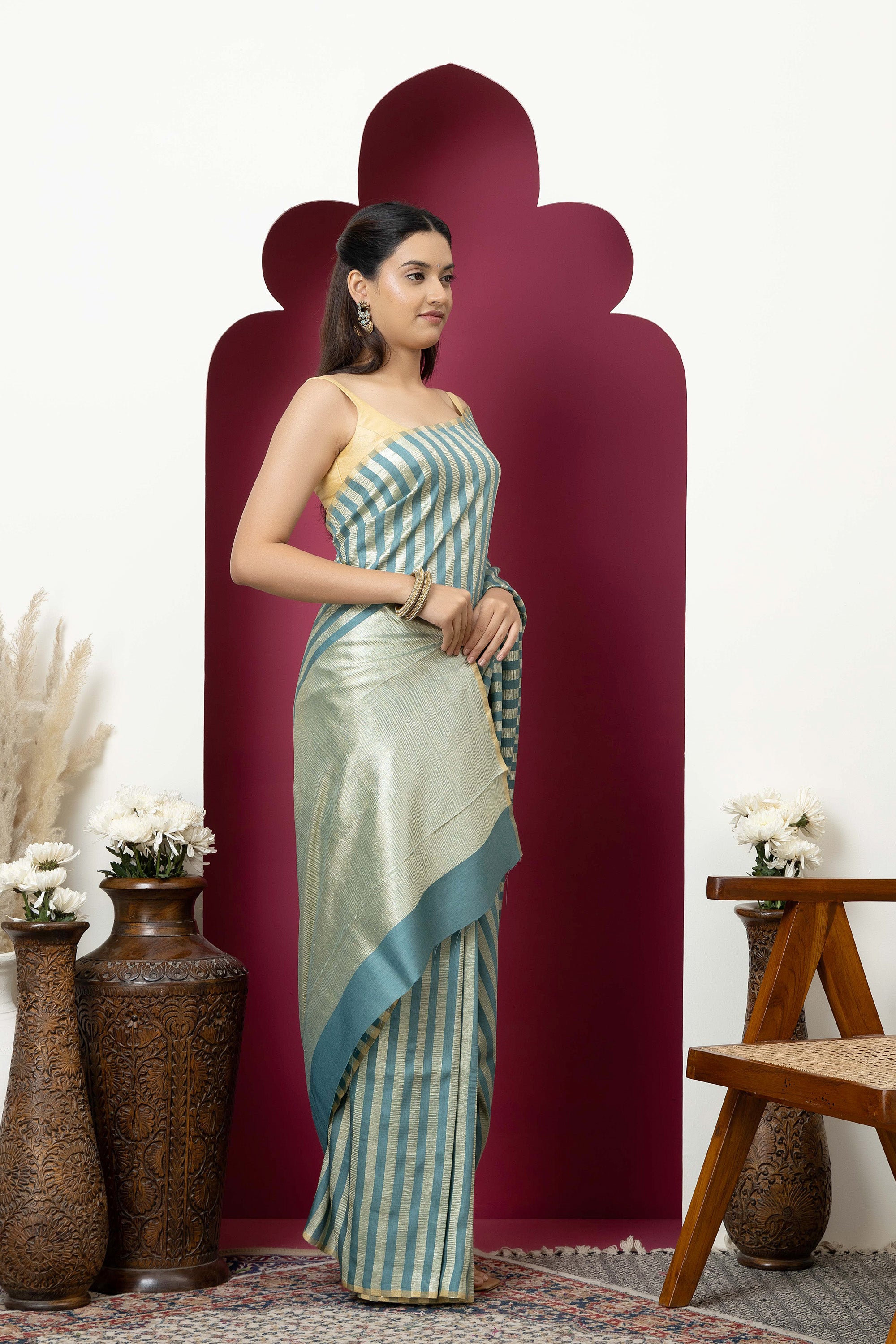 Beautiful Banarasi green pure Muga silk saree with alternate stripes of crinkled tissue and zari pallu