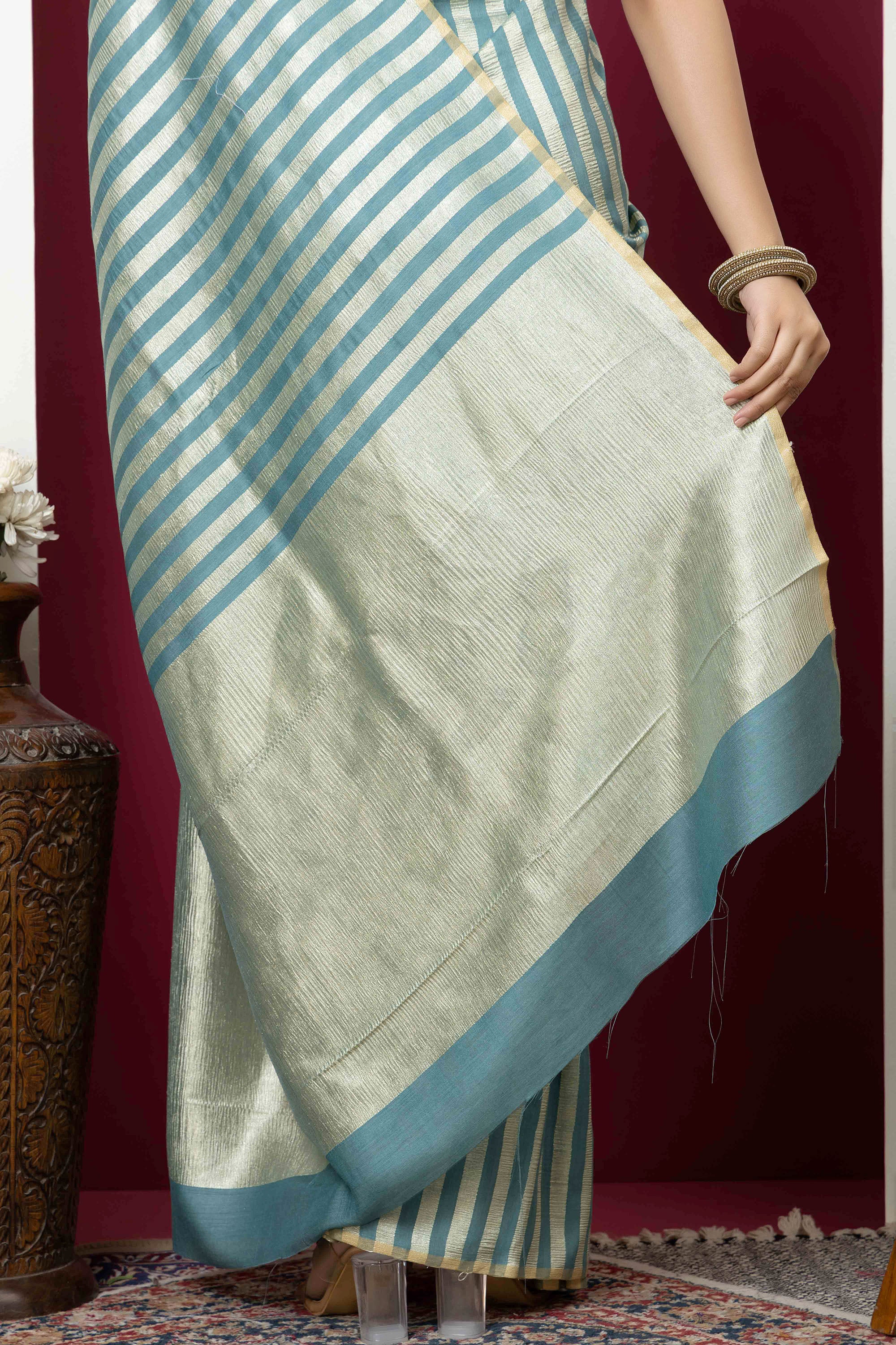Beautiful Banarasi green pure Muga silk saree with alternate stripes of crinkled tissue and zari pallu