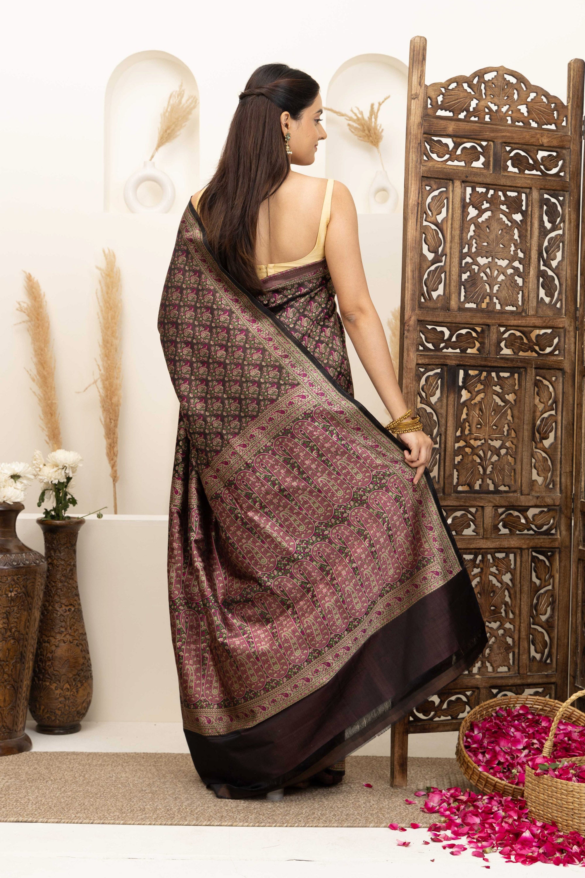 Banarasi pure silk tanchui saree. It’s a rich majenta on brown undertone saree with intricate resham weaving