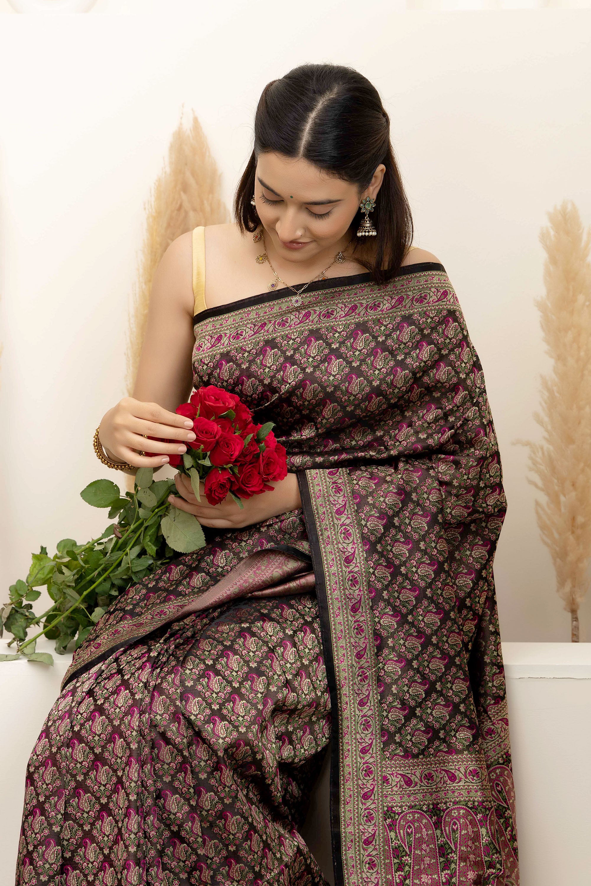 Banarasi pure silk tanchui saree. It’s a rich majenta on brown undertone saree with intricate resham weaving