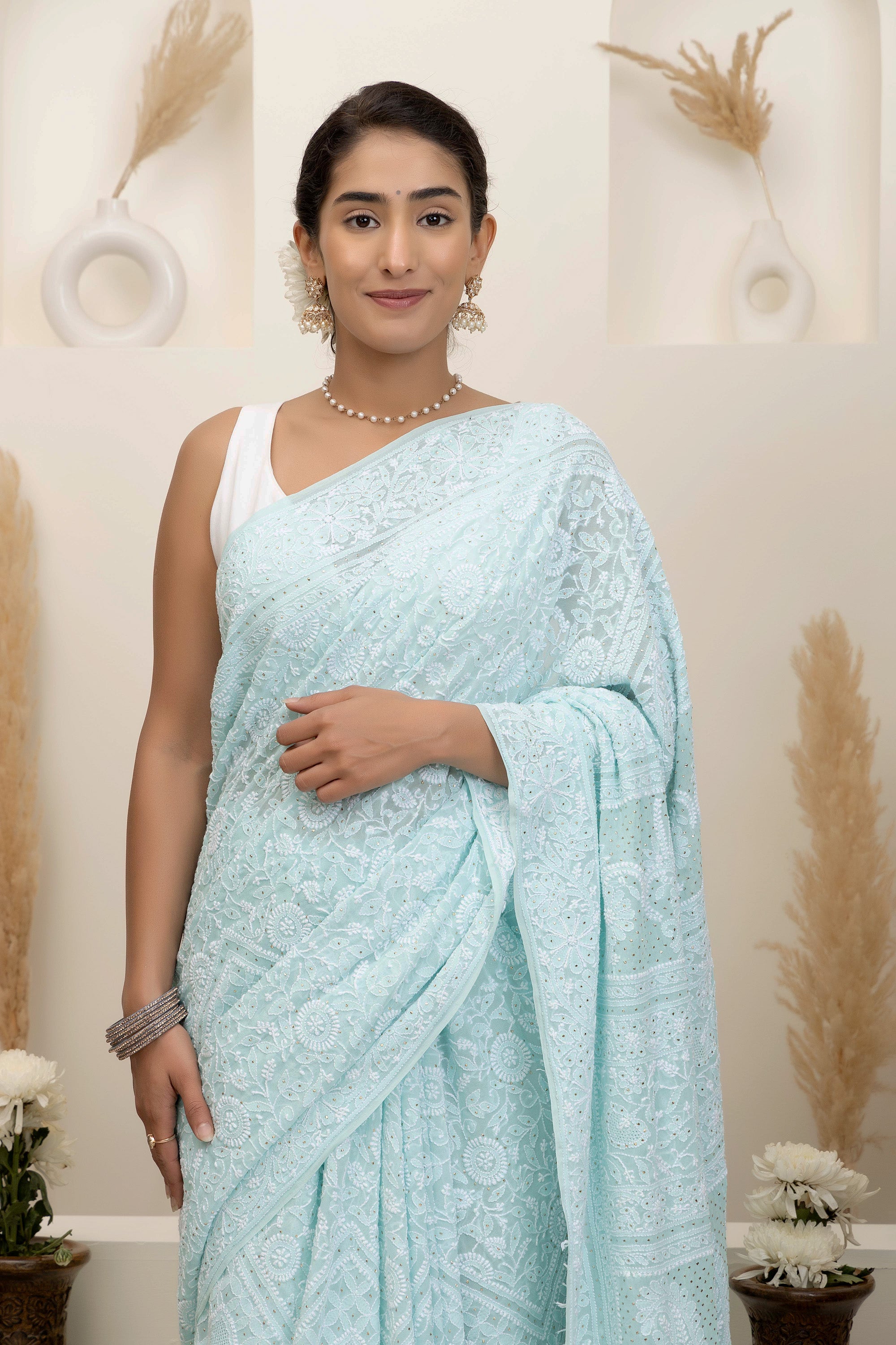 Elegant light blue pure silk georgette saree with fine embroidered Chikankari and mokaish work all over the saree