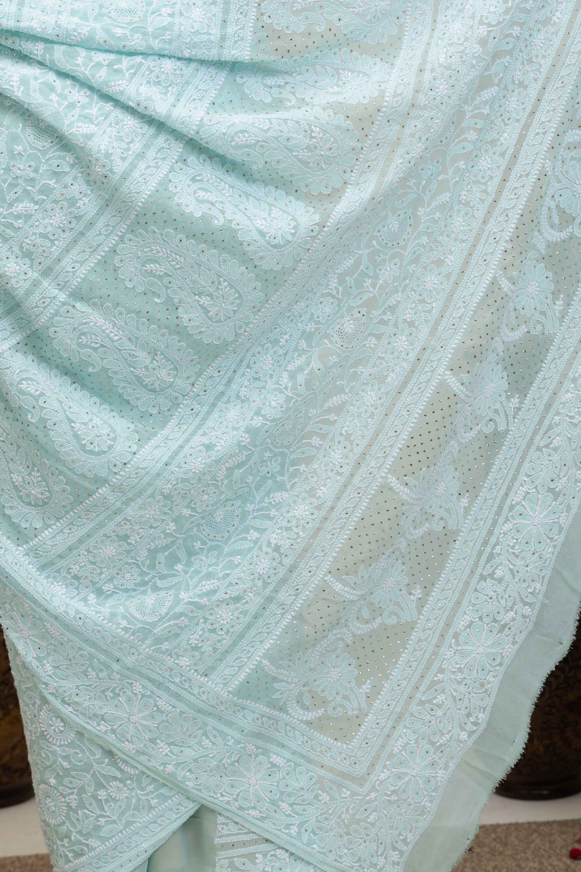Elegant light blue pure silk georgette saree with fine embroidered Chikankari and mokaish work all over the saree